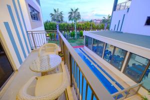a balcony with a table and chairs and a pool at EDEN NEST EXCLUSIVE HOTEL in Belek