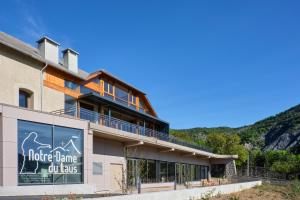 a building with a sign that reads more home oil las at Notre Dame Du Laus in Saint-Étienne-le-Laus +18 photos