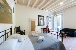 a bedroom with a bed with two towels on it at Nel Cuore di Bologna L ,Bologna by Shortholidays in Bologna