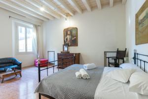 a bedroom with a bed with two white slippers at Nel Cuore di Bologna L ,Bologna by Shortholidays in Bologna