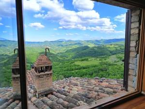 a window view of a mountain view from a building at Chalet Amandola in Moglietta +19 photos