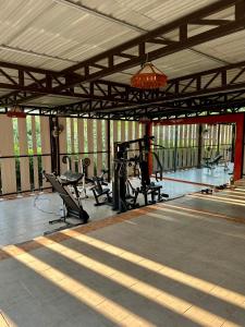 a gymnasium with benches and exercise equipment in it at Paihappy village in Ban Thung Pong