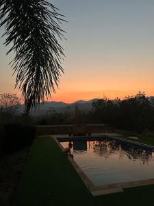 a person sitting in a swimming pool at sunset at Paihappy village in Ban Thung Pong +17 photos