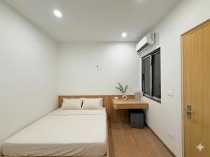 a small bedroom with a bed and a window at Urban Nest - Cầu Giấy in Hanoi