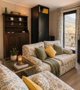 a living room with a couch and a table at ComeCasa La Magdeleine 2BDR APT in La Magdeleine