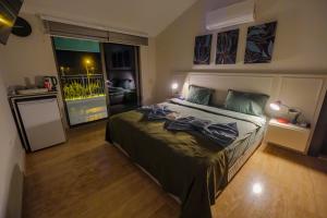 a bedroom with a bed and a large window at EDEN NEST EXCLUSIVE HOTEL in Belek