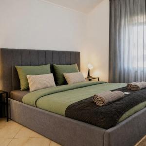 a large bed with two pillows on it in a bedroom at Holiday home Damian - Private pool in Ðurđekovec