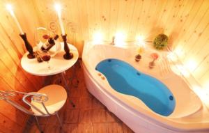 a bathroom with a bath tub and a sink at Chorok Pension in Boryeong