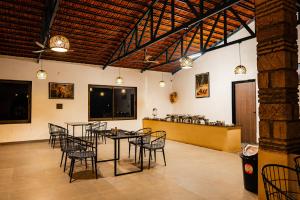 a dining room with tables and chairs and a counter at Aatman Forest Resort - A Luxury Stay in Sasan Gir in Sasan Gir