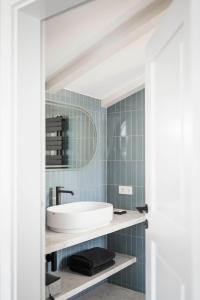 a bathroom with a sink and a mirror at Brixen City Maisonette in Bressanone