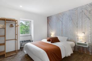 a bedroom with a bed and a wall mural at Casa Aurora in Campo do Gerês +22 photos