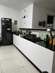 a kitchen with a counter with a clock on the wall at DGH Jasaan in Jasaan