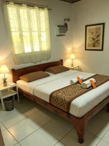 a bedroom with a large bed and a window at DGH Jasaan in Jasaan