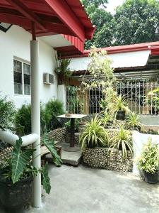 a patio with a table and some plants at DGH Jasaan in Jasaan