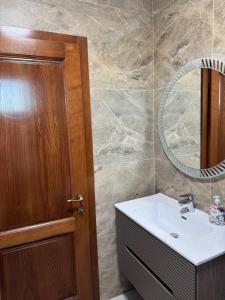 a bathroom with a sink and a mirror at Lucas&Timeea in Caransebeş +26 photos