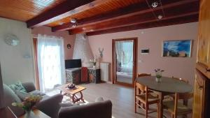 a living room with a table and a couch at Casa della Mamma in Antey-Saint-André