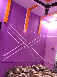 a purple room with a bed in it at Hotel Pawar Palace Mahurgad in Māhūr +5 photos