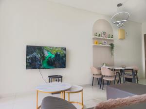 a living room with a tv hanging on the wall at sp13a 55inch tv Netflix 6pax 2park kelab Rahman putra Sungai buloh in Sungai Buluh