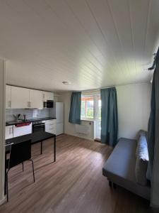 a living room with a couch and a table at Rygge Apartments in Moss