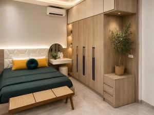 a bedroom with a bed and a wooden cabinet at Bi Room in Hai Phong
