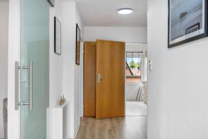 a hallway with a wooden door in a house at Ferienhaus Plüschenworth in Drochtersen +20 photos