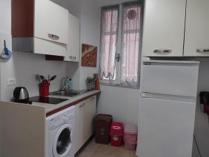 a kitchen with a washing machine and a sink at Petriccioli seaview in Lerici