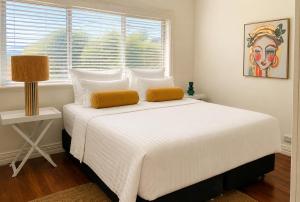 a white bed in a room with a window at Light-Filled Modern Home 3BR Pet-Friendly 5km-CBD in Perth