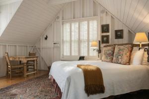 a bedroom with a bed and a desk in a room at Simpson House Inn in Santa Barbara