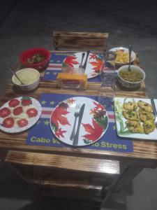 a table with plates and bowls of food on it at Casa Pirinha in Portela +25 photos