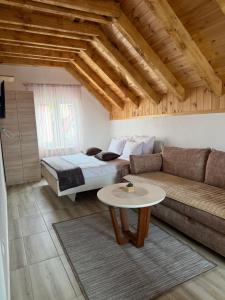 a living room with a bed and a couch at Lux Studio Apartments in Žabljak