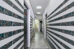 a corridor of an office building with stripes on the wall at Via Ayush Villa, Hiland Park in Kolkata