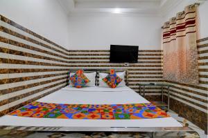 a bedroom with a bed with a wooden headboard at Via Ayush Villa, Hiland Park in Kolkata