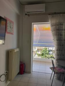 a room with an open door with a view of the ocean at Alkyona in Patra