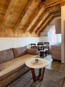 a living room with a couch and a table at Lux Studio Apartments in Žabljak