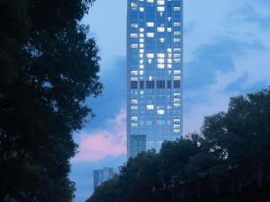 a tall building with many windows on the side of it at Sofitel Nanjing Galaxy Suning in Nanjing
