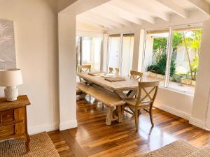 a dining room with a wooden table and chairs at Light-Filled Modern Home 3BR Pet-Friendly 5km-CBD in Perth
