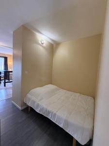 a small bedroom with a bed in the corner at Douglas in Saint Malo