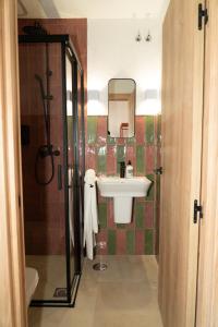 a bathroom with a sink and a mirror at Hostal Playa Pitaya in Torre del Mar +74 photos