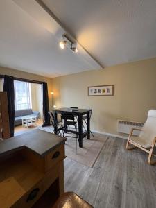 a living room with a table and chairs in it at Douglas in Saint Malo