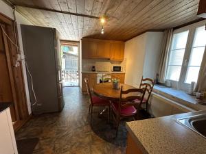 a kitchen with a table and chairs in a room at Chalet Montes in Lauterbrunnen