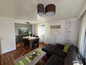 a living room with a couch and a table at Ferienhaus 1 An der Rodach in Steinwiesen