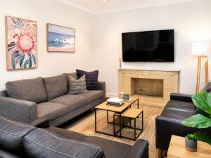 a living room with a couch and a fireplace at Light-Filled Modern Home 3BR Pet-Friendly 5km-CBD in Perth