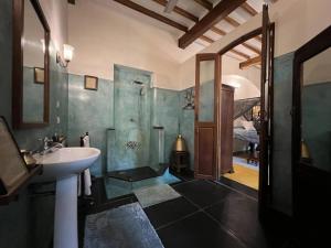 a bathroom with a sink and a shower at Gratitude Heritage in Pondicherry