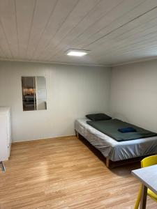 a bedroom with a bed in the corner of a room at Room in a shared apartment in Trondheim