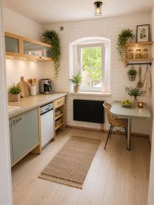 a small kitchen with a table and a window at II Bramasole - Sophia L in Spreewitz