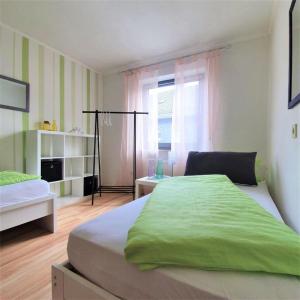 a bedroom with a large bed and a window at Ferienhaus 1 An der Rodach in Steinwiesen