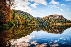 a reflection of a mountain in a lake at Entre Lacs et Sapins in Dortan