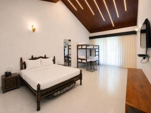 a bedroom with a bed and a flat screen tv at Anand Resort - A luxury Private Pool Resort in Nashik in Nashik