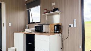 a kitchen with a counter with a microwave on it at Oscars Retreat 1 by Tiny Away in Raworth