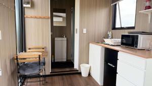 a small kitchen with a counter and a microwave at Oscars Retreat 1 by Tiny Away in Raworth